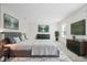Beautifully staged primary bedroom with stylish furniture and ample natural light at 5893 Crosscut Ln, Noblesville, IN 46062