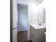 Bathroom with gray vanity and a large arched mirror at 5938 Dunseth Ct, Indianapolis, IN 46254