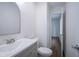 Modern bathroom with gray vanity and hardwood floors at 5938 Dunseth Ct, Indianapolis, IN 46254