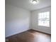Minimal bedroom featuring hardwood floors and a bright window at 5938 Dunseth Ct, Indianapolis, IN 46254