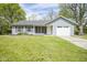 Charming single-story home with light blue siding, an attached garage, and a well-maintained front lawn at 5938 Dunseth Ct, Indianapolis, IN 46254