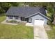 Charming home with blue siding, white trim, red shutters, an attached garage, and a well manicured lawn at 5938 Dunseth Ct, Indianapolis, IN 46254