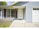 Close-up of the home's entryway, with a white front door, sidelight window, and an attached one-car garage at 5938 Dunseth Ct, Indianapolis, IN 46254