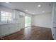 Kitchen area with white cabinets, granite countertops, subway tile backsplash, hardwood floors, and a sliding glass door at 5938 Dunseth Ct, Indianapolis, IN 46254