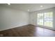 Bright living room with hardwood floors, white walls, recessed lighting, and a window overlooking the front yard at 5938 Dunseth Ct, Indianapolis, IN 46254