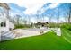 Stunning backyard featuring a covered pool, outdoor kitchen, and lush, well-maintained artificial turf at 5990 Hollow Ct, Bargersville, IN 46106