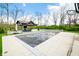 Lush backyard featuring a pool, outdoor kitchen and grill area with beautifully landscaped surroundings, and recreational features at 5990 Hollow Ct, Bargersville, IN 46106