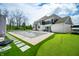 Beautiful backyard with a pool and landscaped areas, including a putting green and lush artificial turf at 5990 Hollow Ct, Bargersville, IN 46106