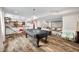 Basement featuring a pool table, projector screen, wet bar, and hardwood floors throughout the living space at 5990 Hollow Ct, Bargersville, IN 46106
