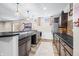 This basement bar is equipped with pendant lighting and stainless steel appliances at 5990 Hollow Ct, Bargersville, IN 46106