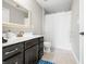 Bathroom featuring a vanity with dark wood cabinets, a toilet, and a shower/tub with white curtain at 5990 Hollow Ct, Bargersville, IN 46106