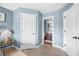 View from main bedroom featuring blue walls, a door to another bedroom or closet, and a view to a bathroom at 5990 Hollow Ct, Bargersville, IN 46106