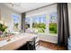 Bright dining area with hardwood floors and view to landscaped backyard at 5990 Hollow Ct, Bargersville, IN 46106