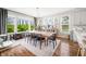 Bright dining room with large windows, hardwood floors, and modern chandelier at 5990 Hollow Ct, Bargersville, IN 46106