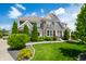 Beautiful two-story home with stone accents, lush landscaping, and a well-manicured lawn at 5990 Hollow Ct, Bargersville, IN 46106