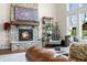 Cozy fireplace with a stone surround, wooden mantel, and decorative shelving adds warmth to the room at 5990 Hollow Ct, Bargersville, IN 46106