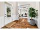 Bright, naturally lit foyer with hardwood floors, white trim, and an adjacent office space at 5990 Hollow Ct, Bargersville, IN 46106
