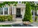 Close-up of the front door showcasing the architectural details, plants, and landscaping at 5990 Hollow Ct, Bargersville, IN 46106