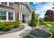Inviting front porch with stone pillars, manicured landscaping, and a charming entrance at 5990 Hollow Ct, Bargersville, IN 46106