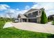 Angle view of a three-car garage, spacious driveway, and partial view of the home's exterior at 5990 Hollow Ct, Bargersville, IN 46106