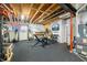 Basement gym features ceiling joists, weights, workout machine, and a basketball hoop at 5990 Hollow Ct, Bargersville, IN 46106