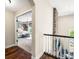 Upstairs hallway showcasing the wood floors and an inviting glimpse into the bedroom at 5990 Hollow Ct, Bargersville, IN 46106