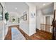 Spacious hallway with wood floors, wainscoting, and framed pictures, leading to the home's entrance at 5990 Hollow Ct, Bargersville, IN 46106