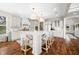 Spacious kitchen with white cabinets, an island with seating and stainless appliances at 5990 Hollow Ct, Bargersville, IN 46106
