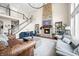 Grand living room with a stone fireplace, high ceilings, and staircase creating a luxurious space at 5990 Hollow Ct, Bargersville, IN 46106