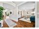 Open-concept living room with hardwood floors, wainscoting, and classic furnishings at 5990 Hollow Ct, Bargersville, IN 46106