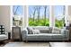 Comfortable living room featuring a stylish gray sofa and large windows at 5990 Hollow Ct, Bargersville, IN 46106