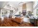 Expansive living room featuring a stone fireplace, staircase, and ample seating for entertaining or relaxation at 5990 Hollow Ct, Bargersville, IN 46106