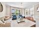 Bright living room showcasing hardwood floors, large windows, and stylish furniture arrangement at 5990 Hollow Ct, Bargersville, IN 46106