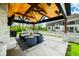 Relaxing outdoor kitchen under wood beams with cozy seating and a built-in grill perfect for entertaining at 5990 Hollow Ct, Bargersville, IN 46106