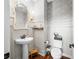Powder room featuring modern wall coverings, a pedestal sink, dark wood floors, and a toilet at 5990 Hollow Ct, Bargersville, IN 46106