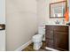 Small powder room featuring a dark wood vanity, white countertop, and simple mirror decor at 5990 Hollow Ct, Bargersville, IN 46106