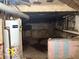 Unfinished basement featuring concrete walls and hot water heater at 616 N Exeter Ave, Indianapolis, IN 46222