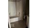 This bathroom features a white tub, tile flooring, and toilet at 616 N Exeter Ave, Indianapolis, IN 46222