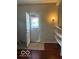 Entryway with a tile floor and an open door; a light fixture adorns the painted wall at 616 N Exeter Ave, Indianapolis, IN 46222