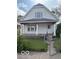 Traditional home with front gate access, a quaint porch with decorative columns, windows, and exterior paint at 616 N Exeter Ave, Indianapolis, IN 46222