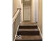 Carpeted stairway with white railing leads to the upper level at 616 N Exeter Ave, Indianapolis, IN 46222