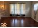 The living room area is accentuated by hardwood floors, curtains, and built-in shelving at 616 N Exeter Ave, Indianapolis, IN 46222