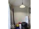 This storage area features a hanging light fixture and essential household supplies at 616 N Exeter Ave, Indianapolis, IN 46222