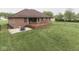 Brick house featuring a deck, patio, fire pit, and a well-manicured lawn at 6494 N Baltimore Rd, Monrovia, IN 46157