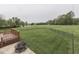 Large, fenced backyard with a well-manicured lawn, fire pit, and deck perfect for outdoor entertaining at 6494 N Baltimore Rd, Monrovia, IN 46157