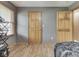 Bedroom with gray walls, wood floor, and wood doors and trim at 6494 N Baltimore Rd, Monrovia, IN 46157