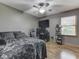 Bedroom with gray walls, ceiling fan, wood floor, and black gaming desk at 6494 N Baltimore Rd, Monrovia, IN 46157