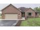 A brick home with an attached garage, a well-manicured lawn and a beautiful entrance at 6494 N Baltimore Rd, Monrovia, IN 46157