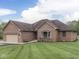 Charming brick home featuring an attached garage and a well-manicured lawn at 6494 N Baltimore Rd, Monrovia, IN 46157