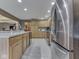 Another kitchen view showing the island, stainless steel refrigerator, and countertops at 6494 N Baltimore Rd, Monrovia, IN 46157